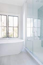 The vanity cabinets and bathtub coping are pale brown mdf. Wood Porcelain Tile White Wood Porcelain Tile Bathroom Floor Tile Ideas Wood Porcel White Bathroom Tiles Porcelain Tile Bathroom Floor Bathroom Interior Design