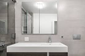 Framing the mirror gives the space more movement and makes the ceiling seem higher. Grey Bathroom Ideas Fontan Architecture