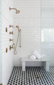 Black And White Geometric Tile A Seamless Glass Shower Door Opens To Black And White Geometric Floor Tiles Fixed Beneath A Sub Beautiful Bathroom Designs Bathroom Shower Tile Doorless Shower