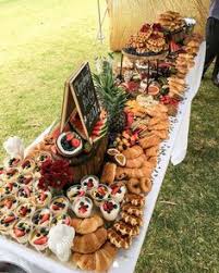 A grazing table is a tablescape filled with artfully arranged meats, cheese, crudité, as well as seasonal fruit, flowers, decorations and serving utensils and dishes. 55 Grazing Table Ideas Grazing Tables Food Platters Wedding Food