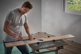 Contractor measuring for cutting new baseboard for renovation. Fitting Laminate And Design Flooring Essentials Package Measuring Tools Products Wolfcraft Site