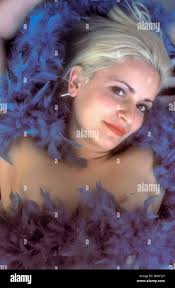 Portrait of 1920s style flapper girl with blue feather boa Stock Photo