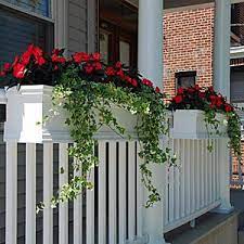 Flower boxes attached to porch and deck railings help to fill empty space between flowering plants in the ground and those in baskets hanging from porch ceilings. Deck Rail Planters Deck Balcony And Porch Railing Planters