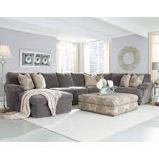 For gorgeous gray living room ideas, offset light gray walls with dark gray shelving for pictures and tie the room together with a comfy gray sofa. Gray Sectional Decor