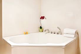 The toilet is discreetly hidden narrow bathrooms can feel frustrating, because they have a high square footage but not much the idea is to protect bathers from peeping toms, but it can also make your bathroom dark and miserable. Modern Corner Bath Ideas Bella Bathrooms Blog