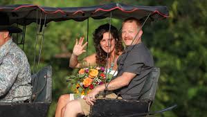 JUST MARRIED! Perry Cline drives the horse and buggy carrying the newlyweds  north