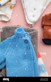 Cute Handmade Knitted Baby Clothes Layout On A Pastel Pink Background Stock Photo Alamy