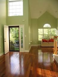 Light Green Walls And High Open Ceilings Balanced By Brazilian Cherry Look Around Living Room Wood Floor Cherry Wood Floors Light Green Walls