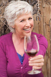 Italy, Tuscany, Siena, young woman tasting red wine in a vineyard at sunset  stock photo