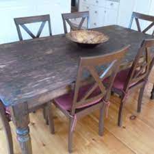 The frame structure of the rustic table showing the reclaimed wood gutters attached to the porch posts. How To Make Your Dining Table Bigger Dengarden