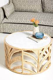 White marble coffee table with iron legs in a brass finish. Anthropologie Marble Top Coffee Table