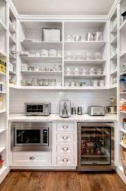 Carving out extra storage room in a kitchen can be difficult, especially when you're working with limited cabinet and countertop space. Pantry Inspiration Above Counter Big Open Shelving Pantry Shelving On Both Sides Hooks For Aprons Home Kitchens Pantry Design Kitchen Design