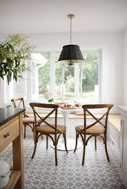 The back and seat frames are inset with a woven wicker and resin in green. Dining Bench With Oval Saarinen Dining Table Transitional Dining Room