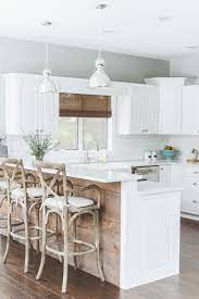 White kitchen with barnwood island. 20 Gorgeous Ways To Add Reclaimed Wood To Your Kitchen