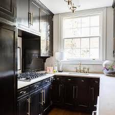 If you live in a loft or studio, black kitchen cabinets are a great way to make your space feel somewhat separate from the rest of your abode. Small Contemporary Black Kitchen Design Ideas