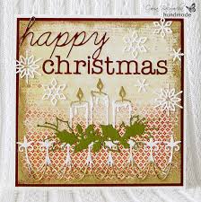 A Christmas Card With Candles Outside The Box
