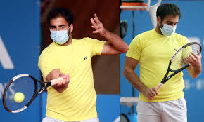 A regulation tennis ball has a mass of 59.4g = 0.0594kg 2. German Tennis Player Benjamin Hassan Wears Face Mask During Tennis Exhibition Series Daily Mail Online