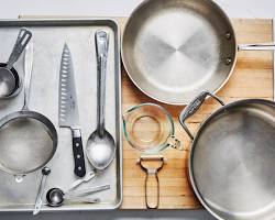 beginner chef in kitchen with utensils surrounding them