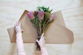 Choose from variety of different bouquets. The Secret To Wrapping A Basic Bouquet So It Looks Beyond Lovely Hunker Small Flower Bouquet How To Wrap Flowers Paper Flower Bouquet