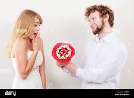Handsome man giving woman candy hi-res stock photography and images