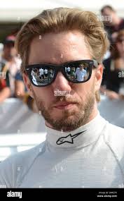 Nick Heidfeld at the Goodwood Festival of Speed with McLaren car engineer  reflected in sunglasses. Driver in pits Stock Photo