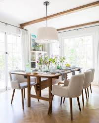 Group of people or team members putting giant lightbulb into light fixture. How To Choose The Perfect Dining Room Light Fixture