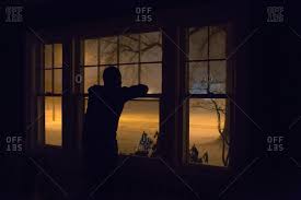Maybe you would like to learn more about one of these? Person Silhouetted At Window Watching Snow Stock Photo Offset