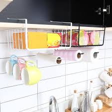 Simply hang a multifunctional storage rack like this one on the side of your fridge and toss your tin foil, parchment paper, sriracha, peanut butter, and other blend the storage needs of all three rooms by storing books and candles on the top shelf while hanging pots and pans on the bottom hooks. Hanging Kitchen Cupboard Shelf Basket Holder Cabinet Storage Rack Home Organizer Kitchen Storage Organization Home Garden