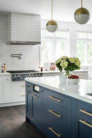 Accent colors include a deep brown range hood, black kitchen island, and deep grey marble countertops. 75 Beautiful Kitchen With Blue Cabinets And Quartz Countertops Pictures Ideas June 2021 Houzz