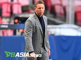 With a grey checkered suit jacket alongside a black shirt, waistcoat, and slacks; Dbasia News Julian Nagelsmann Commented On The Failure Of His Team In The Champions League Semifinals Dbasia News