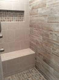 All the bathroom fixtures and accessories are finished in white to let the decor of the room popped out perfectly. Walk In Shower With Grey And Beige Toned Tiles Grey And Beige Bathroom Gray Bathroom Decor Beige And Grey Bathroom