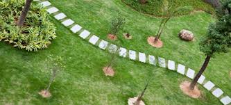 Start laying the paving stones in one corner. How To Lay Paving Slabs On Grass