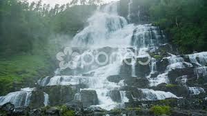 It is located about 12 kilometres (7.5 mi) north of the village of vossevangen along the european route e16 road to flåm. Tvindefossen Waterfall Trollafossen Vo Stock Video Pond5