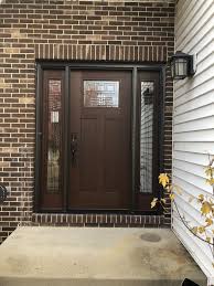 Installed In Lake Zurich This Albany Door With Sidelights Exudes Warmth And The Decorative Glass Adds Ju Installing Exterior Door Brown Front Doors Door Design