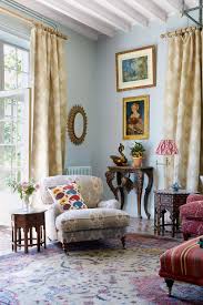 In the blue living room of susan deliss' french country house, a striped ottoman is used as a coffee table. Country Living Room Ideas House Garden