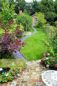 Elevated View Of Long Narrow Town Garden With Lawn And Sinuous Path Leading To Garden Studio Brick Pavin Narrow Garden Back Garden Design Small Garden Layout