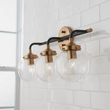 Your towel bars, mirror, knobs, light fixtures, faucets, and showerheads all offer opportunities to try this trend for yourself. Bathroom Lighting Burke Decor