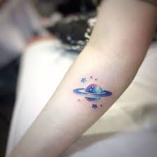 Small Forearm Tattoo Of Planet With Stars Around It Moon And Stars Tattoo Galaxy Colors Inside Galaxy Tattoo Tattoos Ankle Tattoos For Women