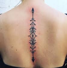 Geometric Arrow Spine Tattoo With Teal Accents Tattoos Geometric Arrow Tattoo Twin Flame Tattoos