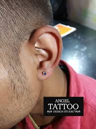 The woman piercing your ear is a shop clerk hired to stock shelves and ring up sales. Tattoo Shops Near Me Ear Piercing Tattoo Design