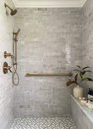 The black hexagon tiles in this grayscale bathroom from studio mcgee are not for the faint of heart, but they are the perfect anchor for a classy and sophisticated space with white subway tile covering the lower walls. The Best Tile For Bathroom Floors According To Designers Best Bathroom Tiles Amazing Bathrooms Bathroom Design