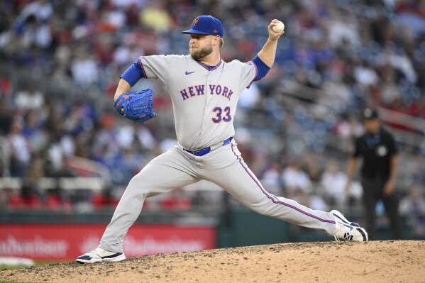 Mets reliever A.J. Minter goes on the injured list with a strained left lat | AP News