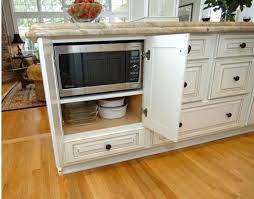 The kitchen is also equipped with plugmold so that all outlets are hidden outlets and there is no interruption to the backsplash. Disappearing Microwaves Centsational Style Kitchen Design Kitchen Remodel Microwave In Kitchen