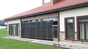 The sunroom addition (on the right with windows) and new deck. 4 Track Vinyl Stacking Windows Screened Room Three Season Porch Craft Bilt