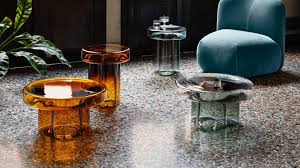 The table features an elegant and sophisticated design with a metal frame, four cabriole legs with triangular detailing, a carved x base and ball finials. Yiannis Ghikas Creates Blown Glass Soda Coffee Table For Miniforms