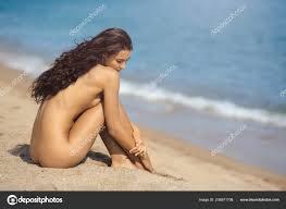 Nude beautiful woman on the nudist beach. Lady with nude perfect body.  Stock Photo by ©dimabl 238971708
