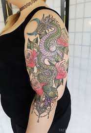 A dragon and rose tattoo is usually quite simple with a back or black and red dragon wrapped around a red rose tattoo. Dragon Roses Tattoo Abyss Montreal