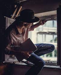 Guy In Big Hat Sitting In The Window Big Hat Logo Children Guys