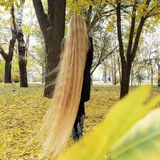 She wears an ankle length purple dress and goes barefoot. The Real Life Rapunzel Shares Tips About Having A Hair As Long And Beautiful As Hers