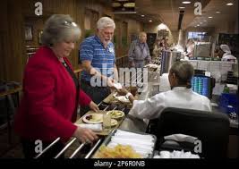 Margie, left, and Mark Hinsdale go through the serving line at the K&W  Cafeteria